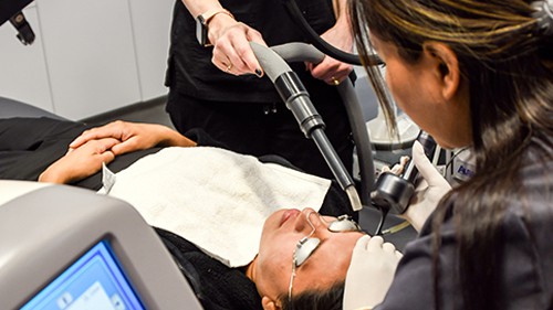 A nurse uses a CO2 Fractional laser on a patient during laser treatment for acne.