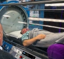 Dr. Milgrom on Phone with Patient in our Hyperbaric Oxygen Therapy Chamber