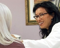 Dr. Pien observing the positive results on a patient's facial scars