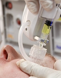 Medi-inject injecting stem cells into patient's face to heal acne scars.