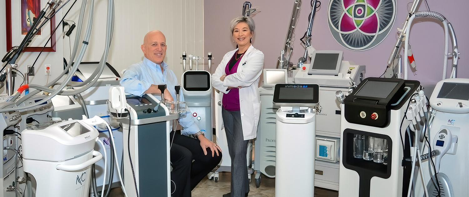 Dr. Milgrom and Dr. Pien posing with their 30 + medical lasers.